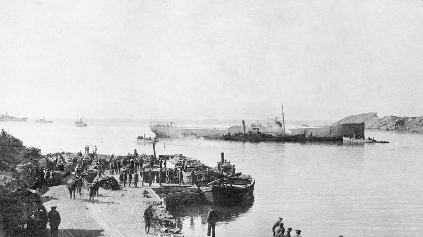 The 1st Royal Australian Naval Bridging Train tow into place an old hulk to form a breakwater for the boat dock at West Beach, Gallipoli in 1915.