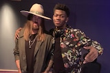 Lil Nas X stands with his arm around country music singer Billy Ray Cyrus.