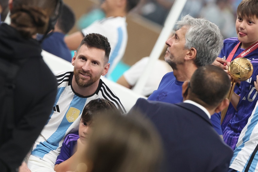 Lionel Messi and father Jorge on the field after the World Cup final.