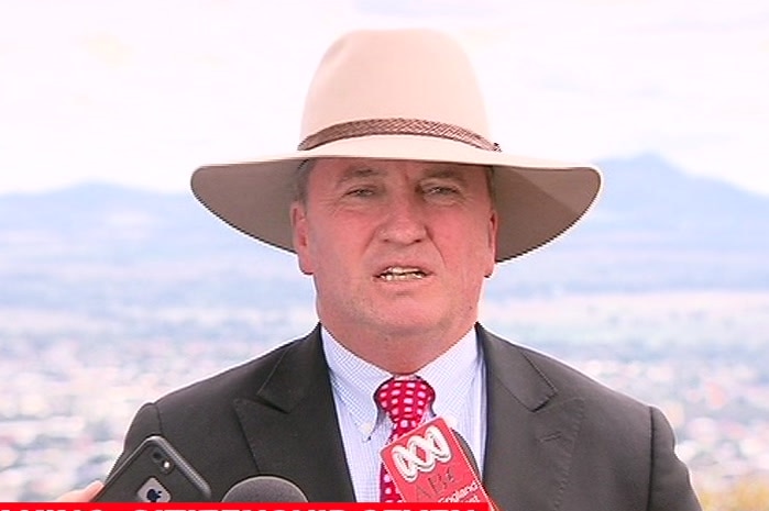 Barnaby Joyce wears a wide-brimmed hat and speaks towards the camera.