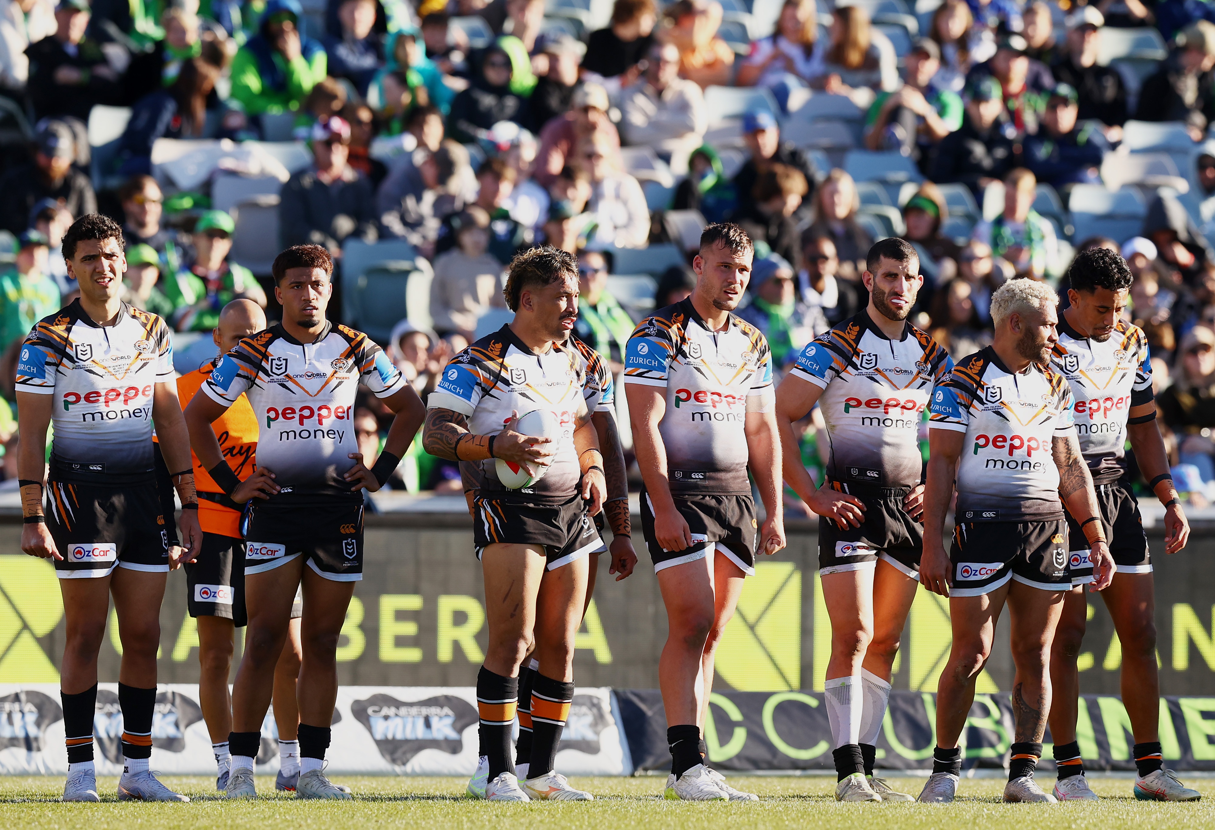A group of NRL players look sad after conceding a try 