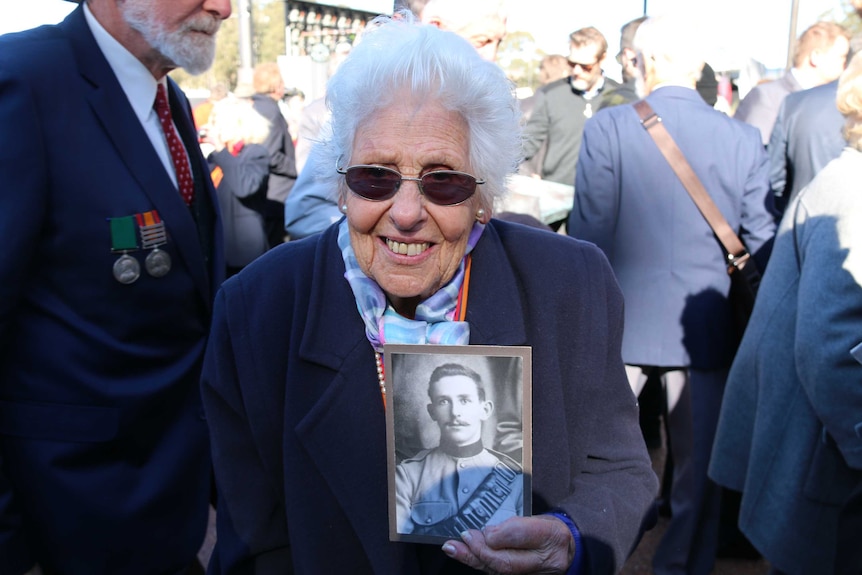 Portrait of 94 year old Mary Carter from Sydney holding a photo of her father who served in the Boer War.