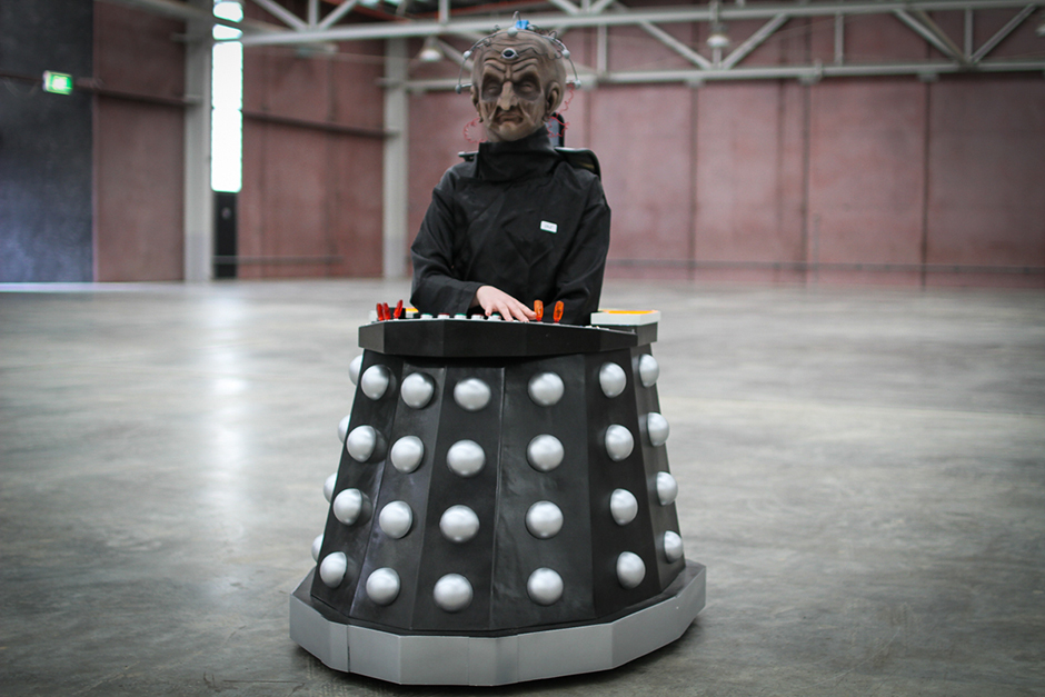 A woman in a mask, black jacket and a Dalek 'skirt'.