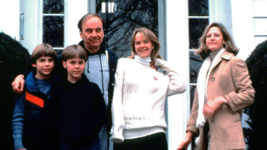 Rupert Murdoch with his arms around his three children while wife Anne smiles