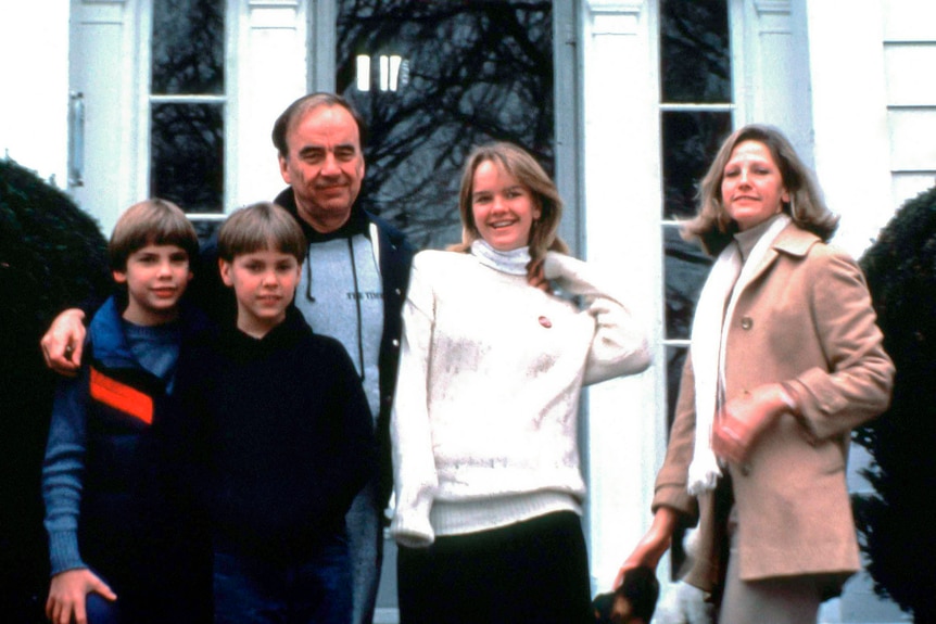 Rupert Murdoch with his arms around his three children while wife Anne smiles