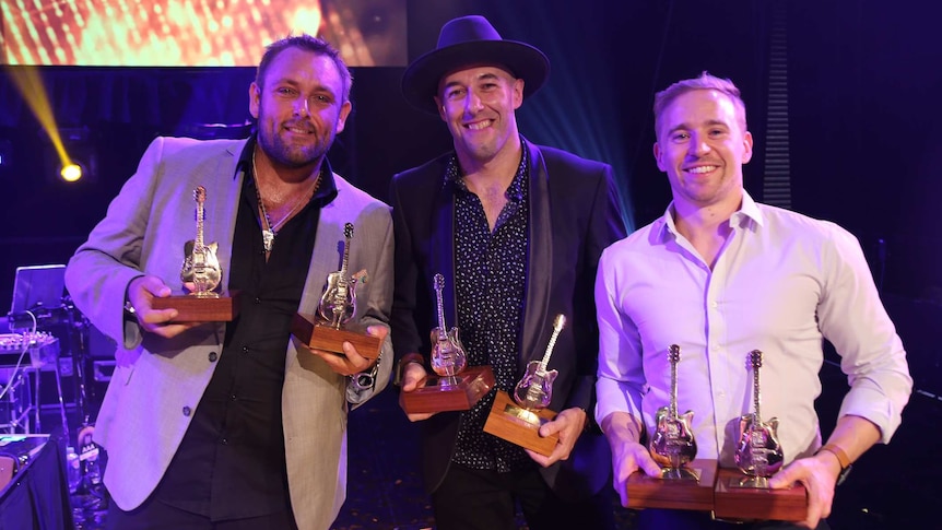 The Wolfe Brothers holding their Golden Guitar awards.