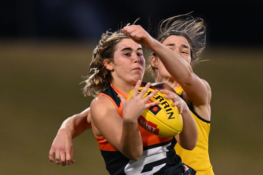 Zarlie Goldsworthy has a defender behind her as she marks the ball on her chest