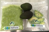 A fresh avocado next to packaged processed product.