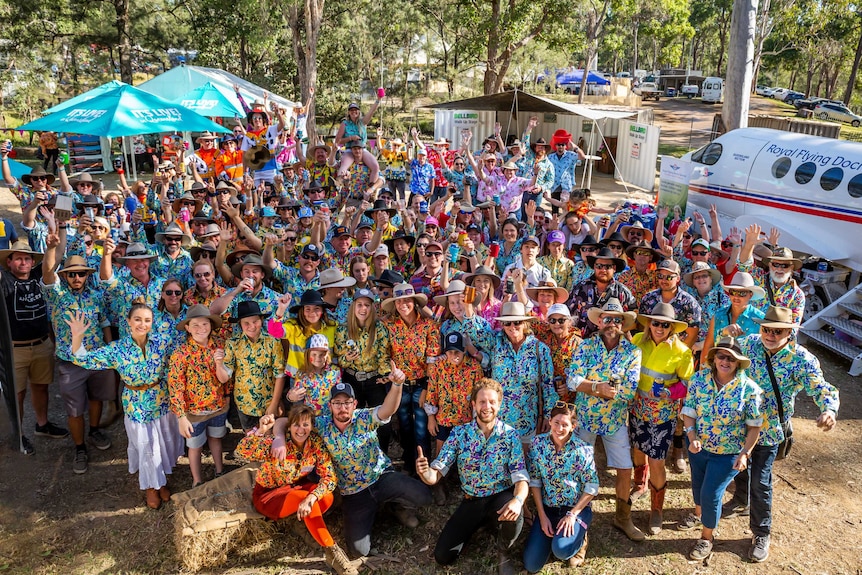 A large crowd of people wearing brightly coloured shirts