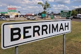 A street sign of the Northern Territory suburb of Berrimah, with shops in the background.