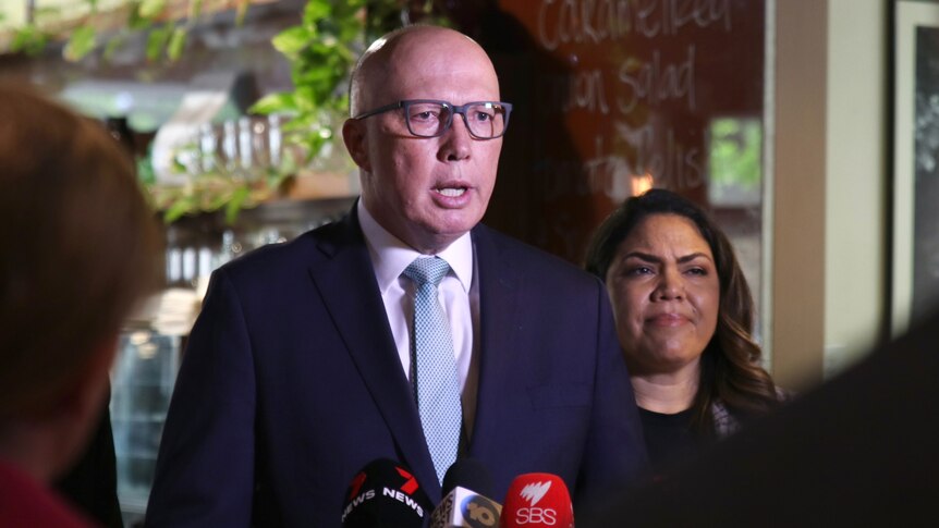 Peter Dutton speaks into microphones at a media conference standing in front of Senator Jacinta Nampijinpa Price.