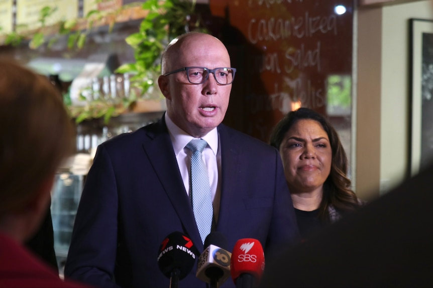 Peter Dutton speaks into microphones at a media conference standing in front of Senator Jacinta Nampijinpa Price.