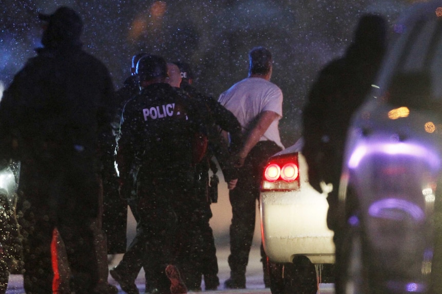 The handcuffed suspected gunman at the Planned Parenthood clinic.