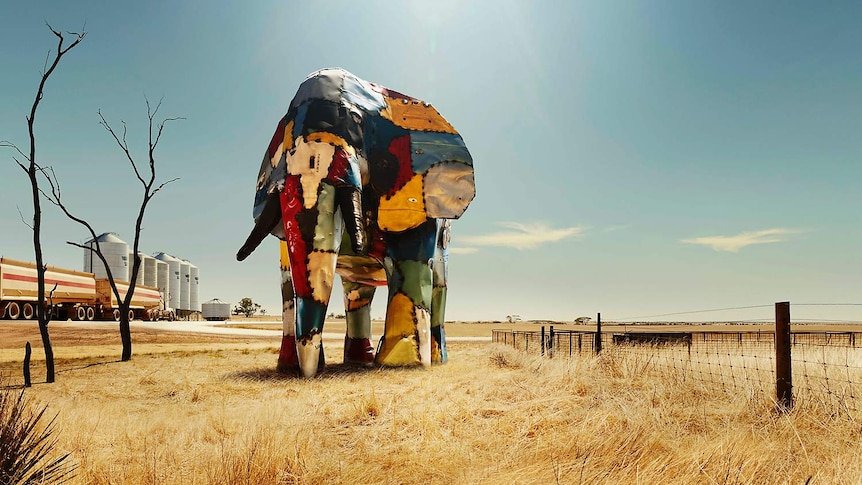 Elephant made out of crashed car parts next to a silo in the Wheatbelt