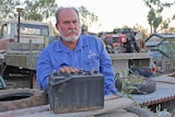 Burke Shire mayor and grazier Ernie Camp with a battery in his dump