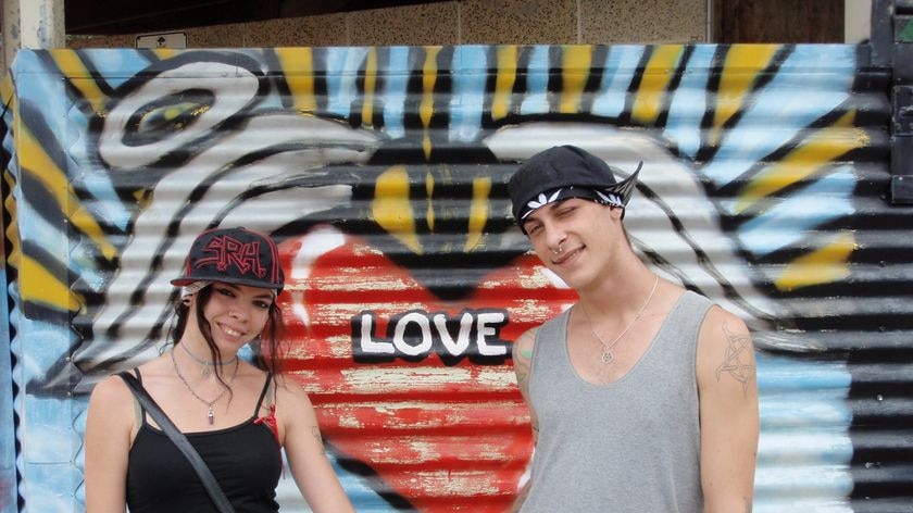 Logan locals Chris and Ann pose in front of a graffiti wall in Logan on November 18, 2009.