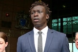 North Melbourne AFL player Majak Daw leaves the Melbourne Magistrates Court.