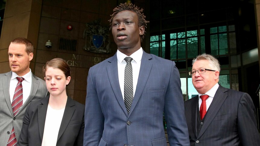 North Melbourne AFL player Majak Daw leaves the Melbourne Magistrates Court.