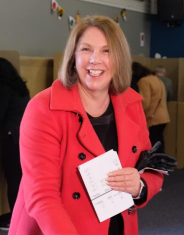 federal politician catherine king smiling with ballot papers in Ballarat