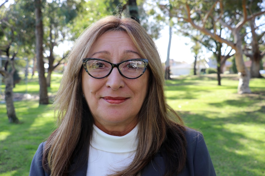 A woman wearing glasses, in headshot