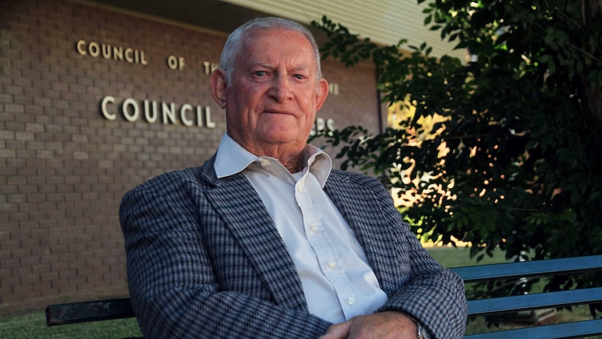Bourke Shire Council mayor Barry Hollman sits on a park chair outside the council's headquarters.