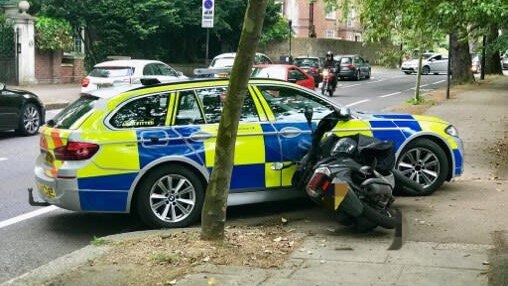 Met Police car alongside shunted scooter