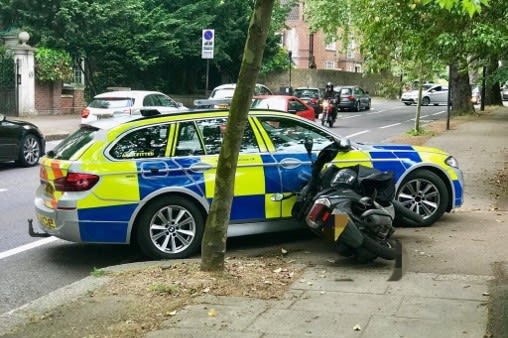 Met Police car alongside shunted scooter