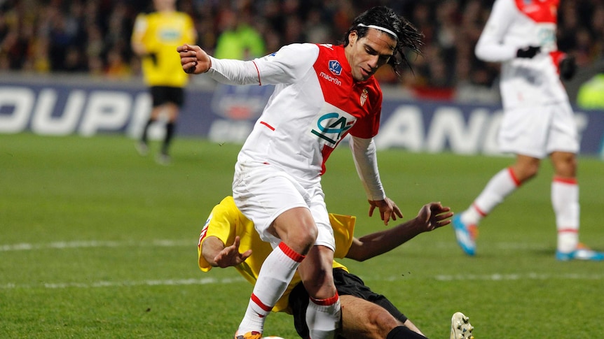 Monaco's Falcao holds off a defender