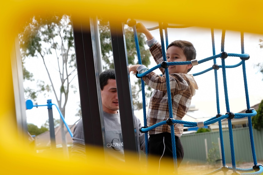 Sadam Abdusalam and Lutfi on play equipment.