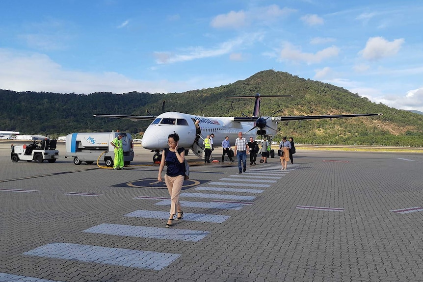 A Qantas propeller plane on the tarmac of a regional airport