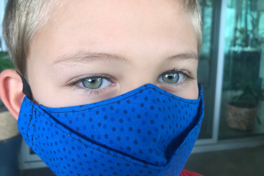 A generic image of a child in a mask.