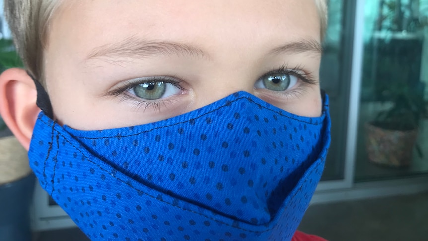 A generic image of a child in a mask.