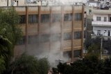Smoke rises from a rocket attack in the western Syrian city of Homs.