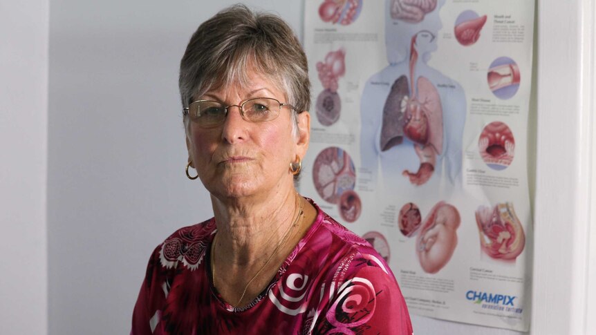 Josie Price sits in front of a medical chart showing human organs