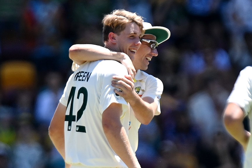 Australia Test cricket captain Pat Cummins puts his arm around Cameron Green during the first Ashes Test at the Gabba.