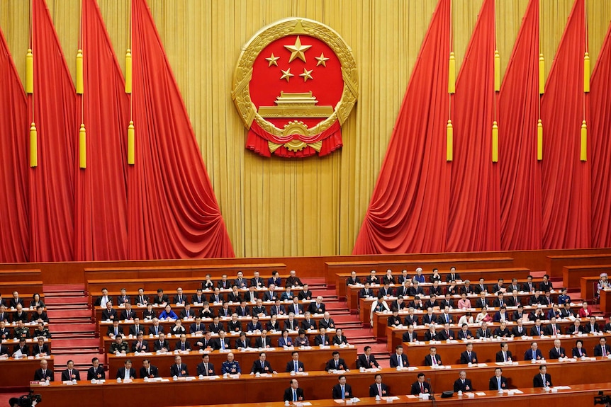 Delegates attend the third plenary session of the National People's Congress at the Great Hall of the People in Beijing.