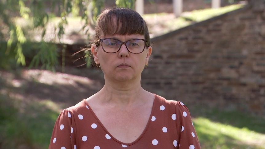  Louise Flood standing in a park with a concerned look on her face