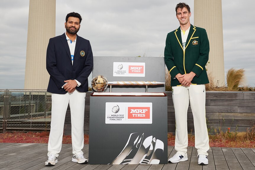 Rohit Sharma and Pat Cummins stand in front of Battersea Powerstation