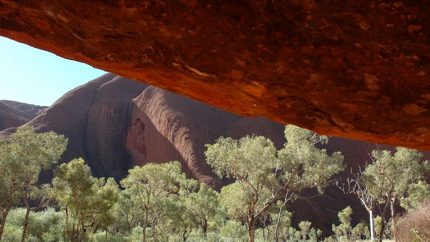 A view from a rock cave at the base of Uluru on the Kuniya Walk.