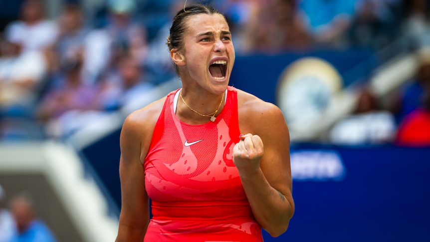 A Belarusian female tennis player pumps her left fist as she celebrates winning a point at the US Open.