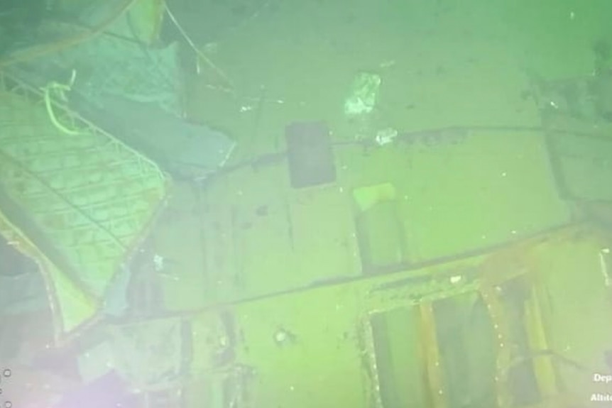 A grainy image of submarine wreckage underwater