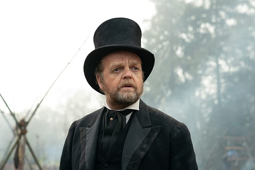 Film still of Toby Jones as Chief Factor wearing a top hat in First Cow