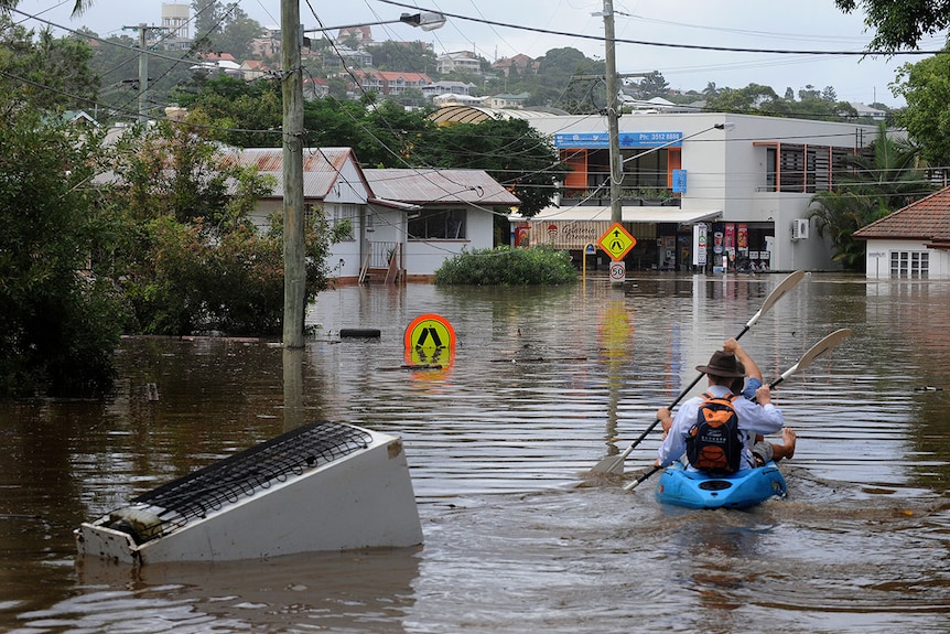 Kayakers explore a flooded street in  the Brisbane suburb of Rosalie during the 2011 floods.