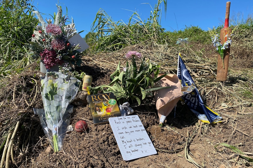 Floral tributes and a bat laid at the side of the road where Andrew Symonds had a fatal car crash.