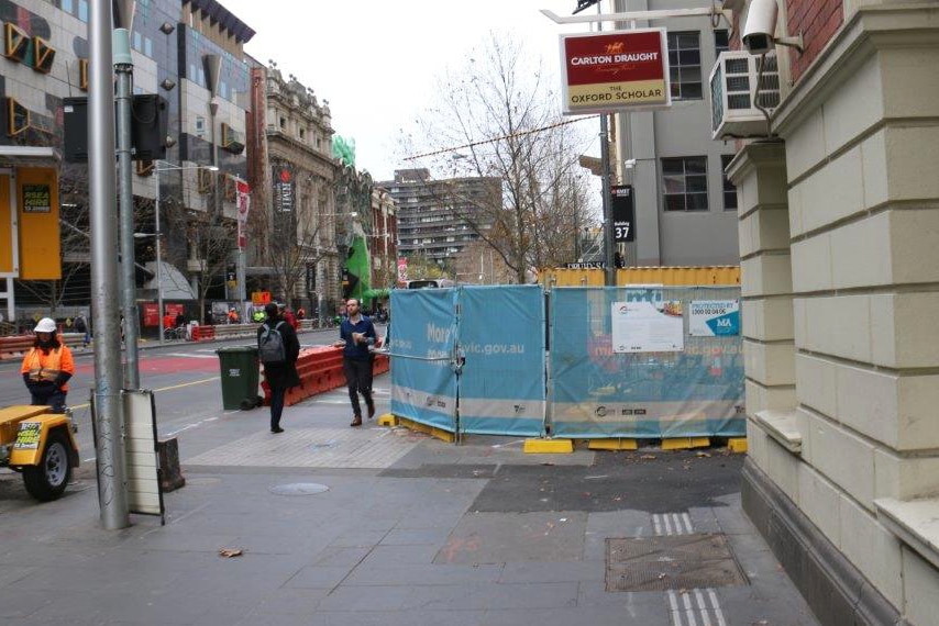 Construction barriers cover the footpath outside the Oxford Scholar hotel.