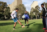 Young people take part in a football training session as part of the United Through Football community outreach program