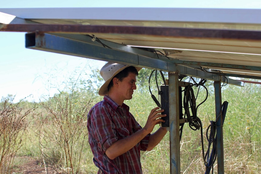 a man checking a solar powered bore