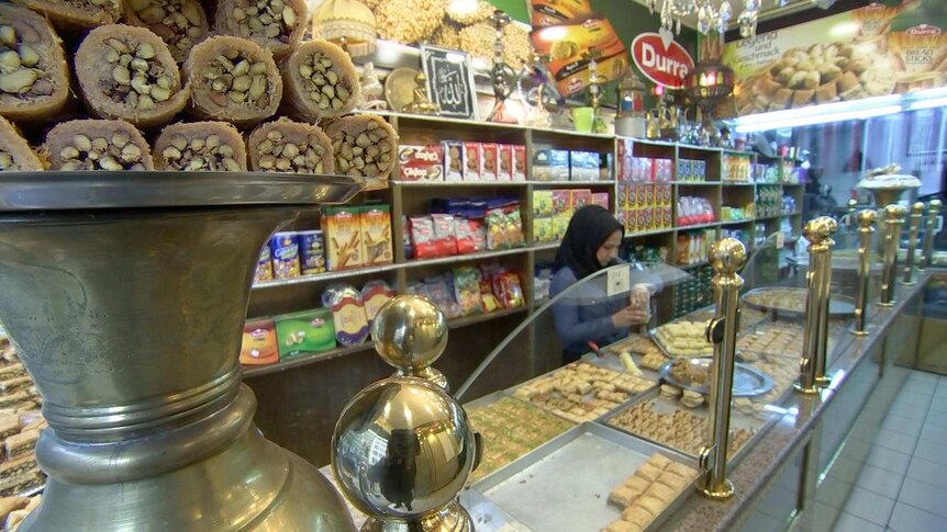 A woman works behind the counter in a turkish bakery in germany