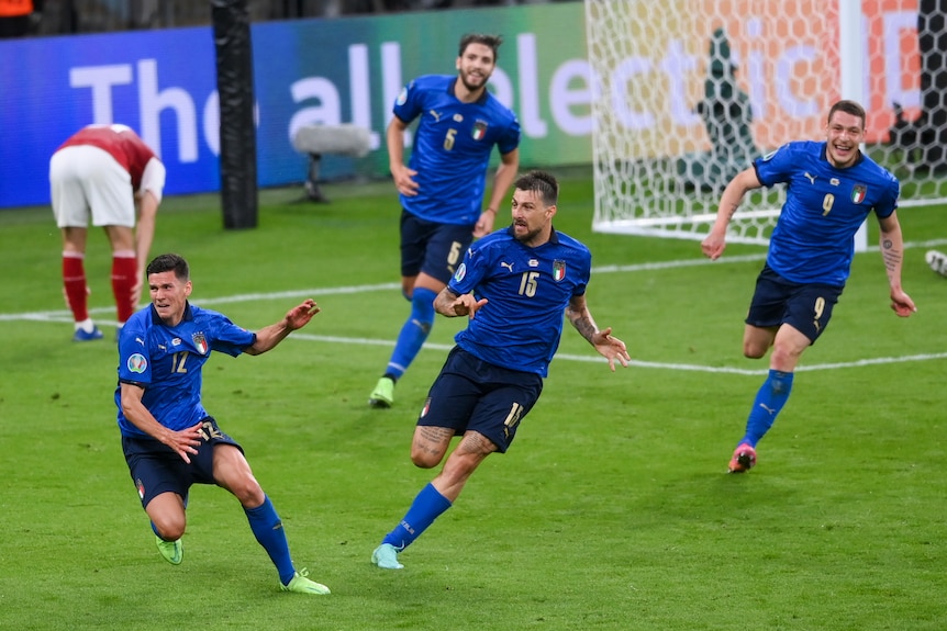 Italian footballers run around the pitch in celebration after a goal at Euro 2020.