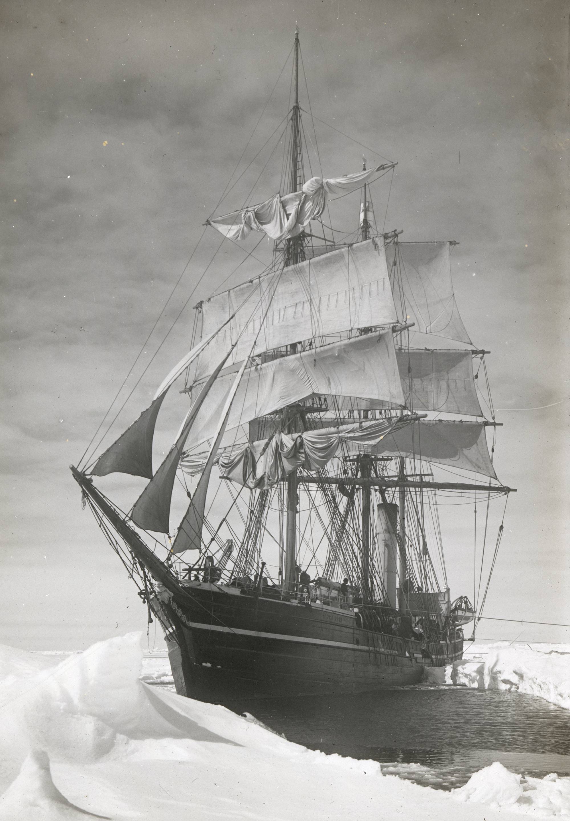 A tall ship is surrounded by ice.